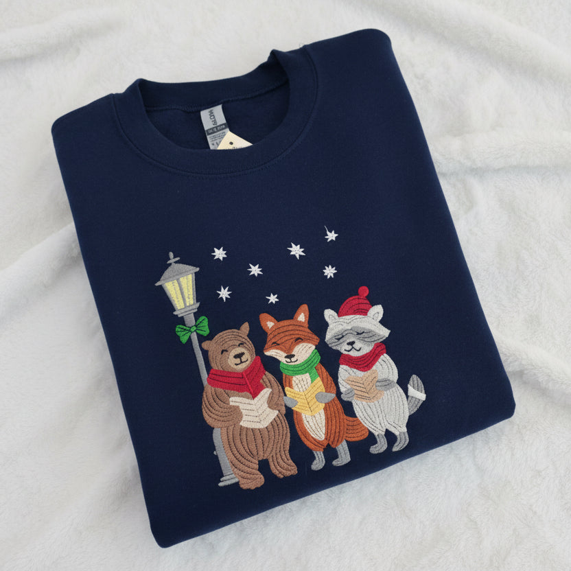 Folded navy blue sweatshirt with cartoon animals design on a white background