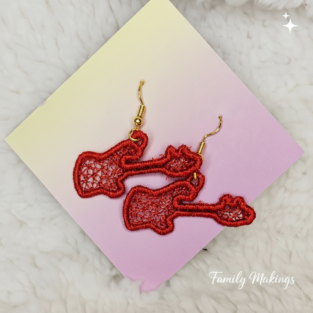 Embroidered red guitar earrings on a card