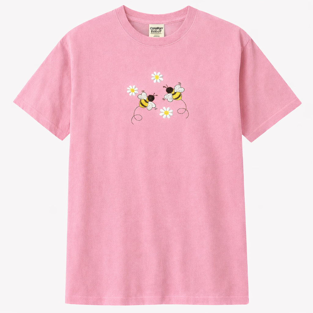 Light pink t-shirt with bee and flower design on a white background