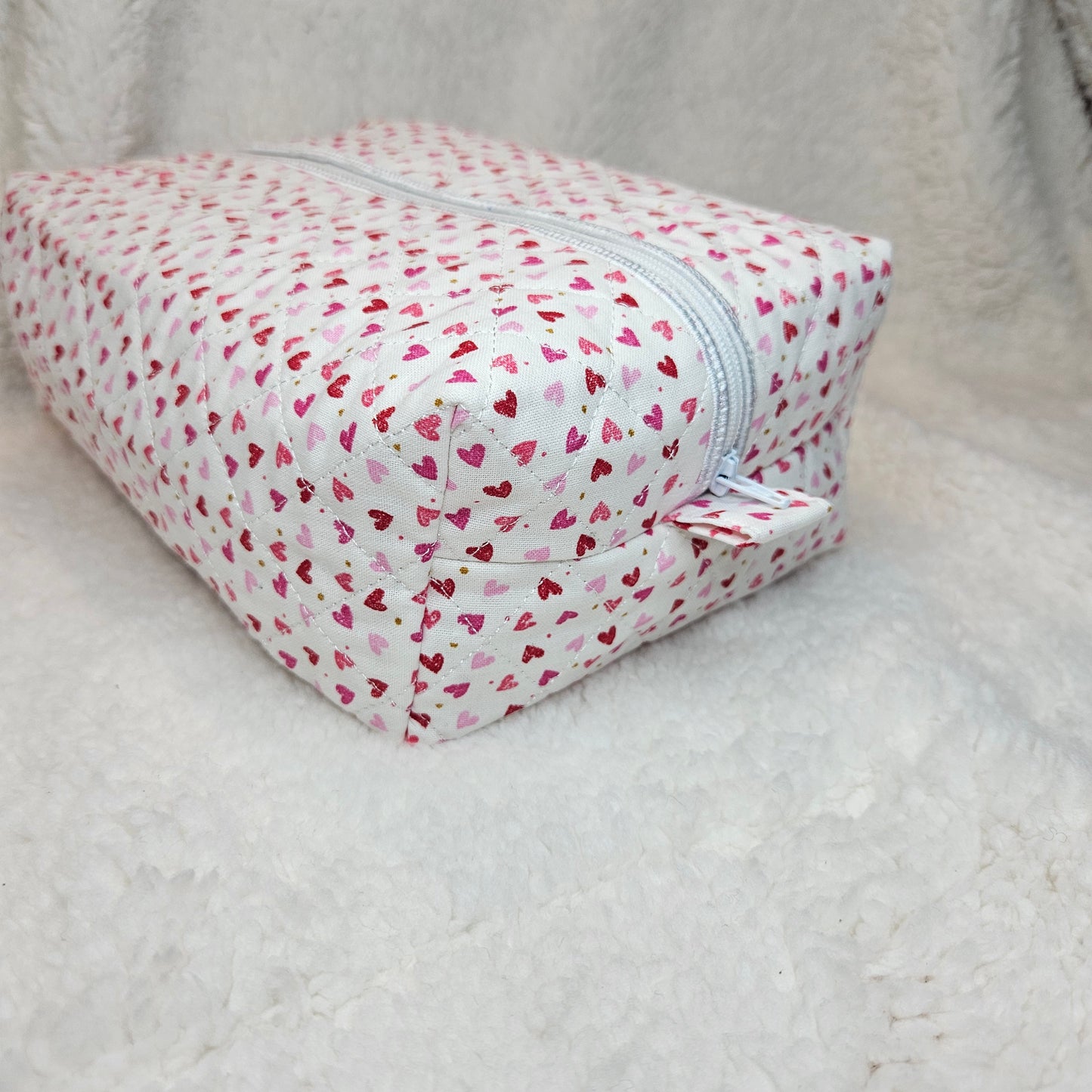 Small pouch with heart pattern on a light gray background