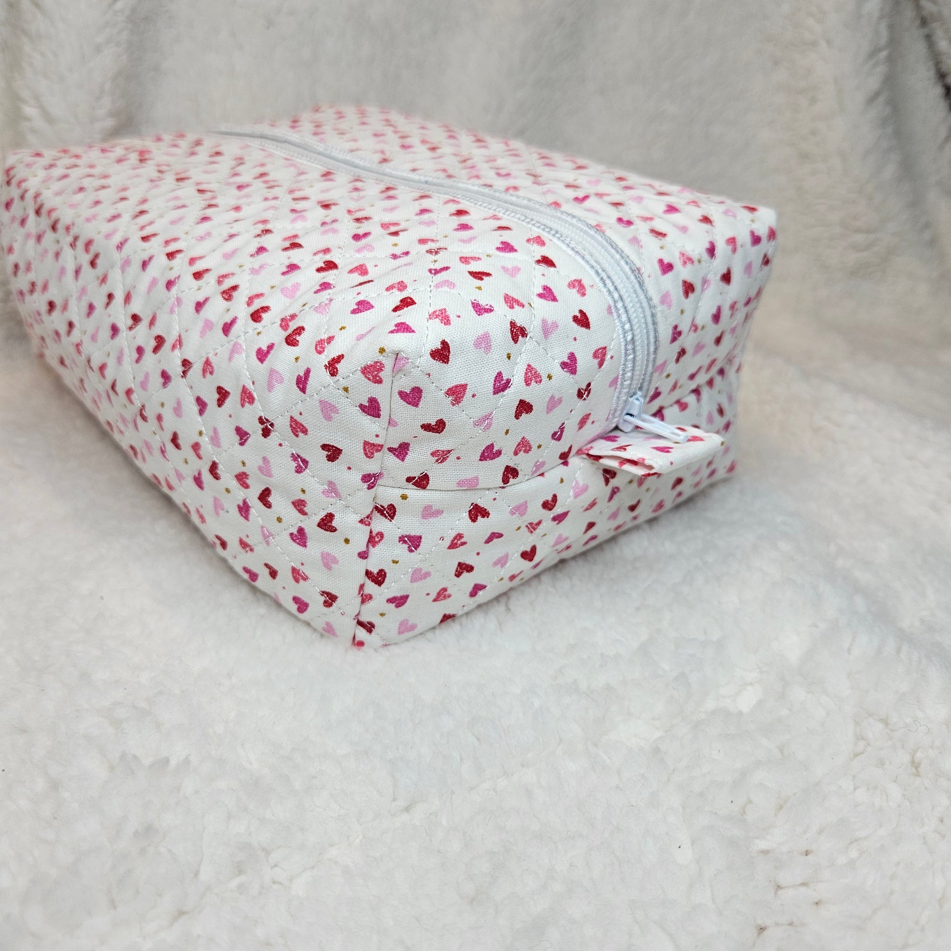 Small pouch with heart pattern on a light gray background