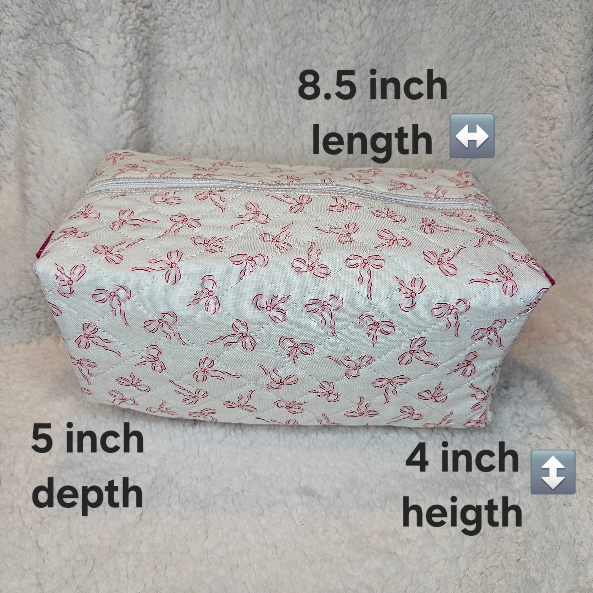 Rectangular pouch with bow pattern on a textured surface, showing dimensions.
