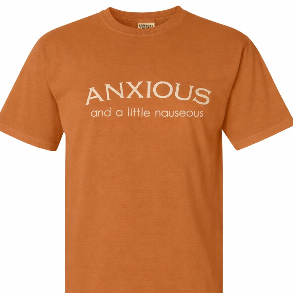 Yam t-shirt with beige embroidered text 'ANXIOUS and a little nauseous' on a white background