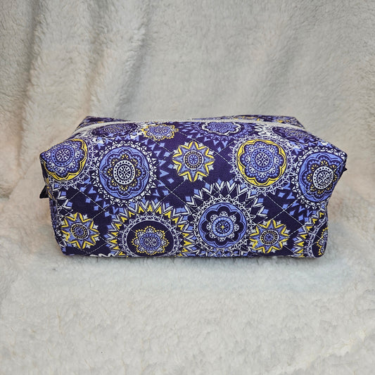 Purple and yellow patterned fabric on a white textured background