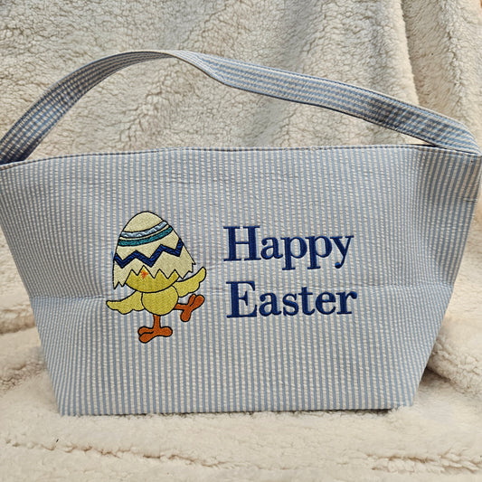 Blue striped bag with 'Happy Easter' text and chick design embroidered on a textured surface
