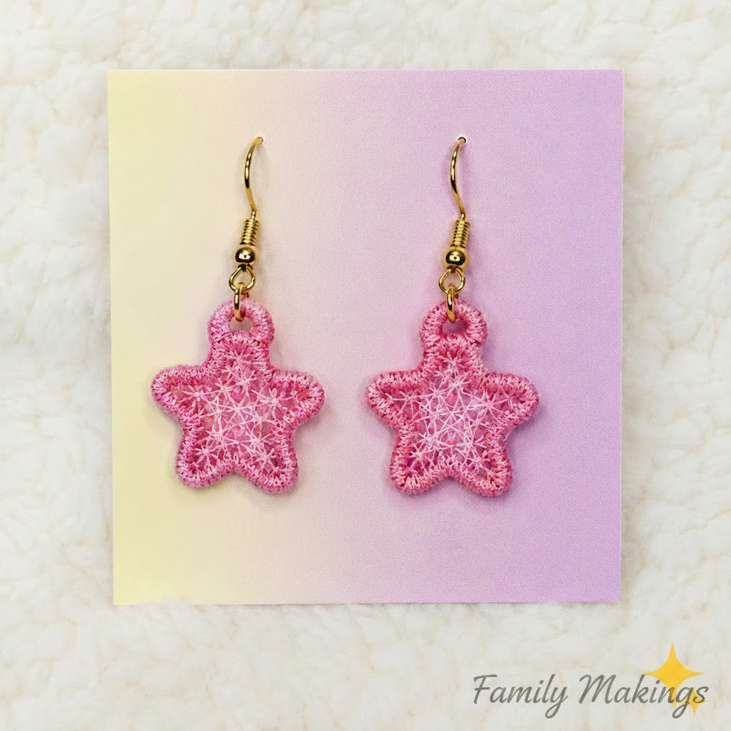 Pink colored embroidered star earrings on a card