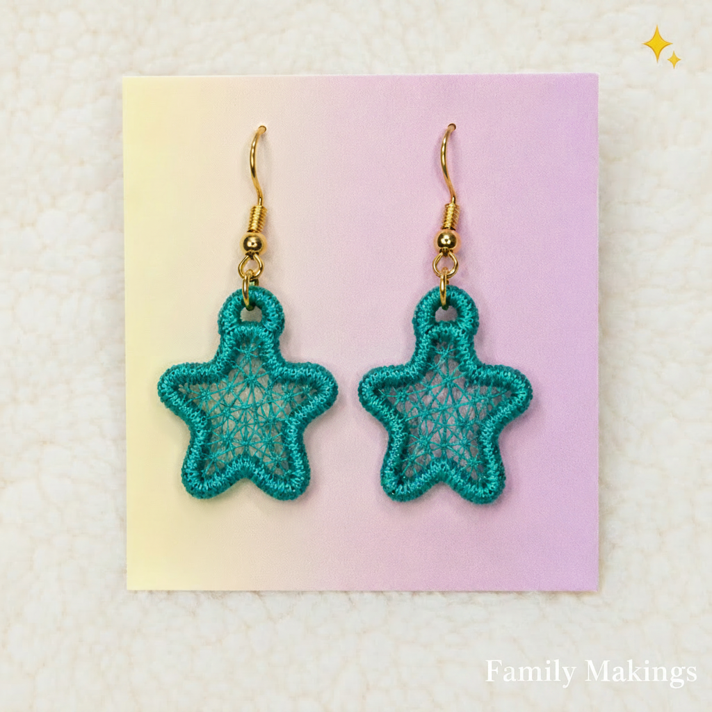 Teal colored embroidered star earrings on a card