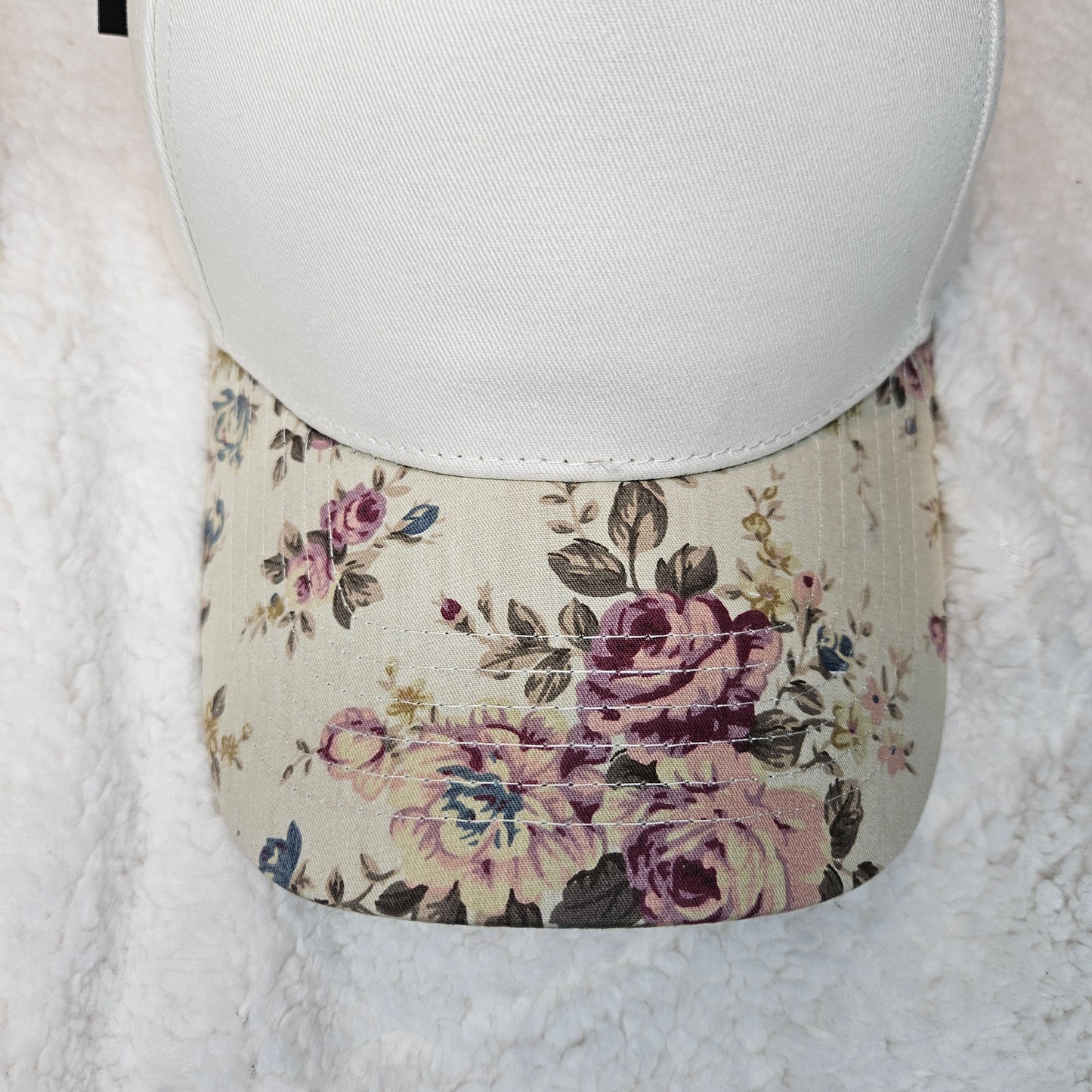 Floral-patterned hat brim with a white surface