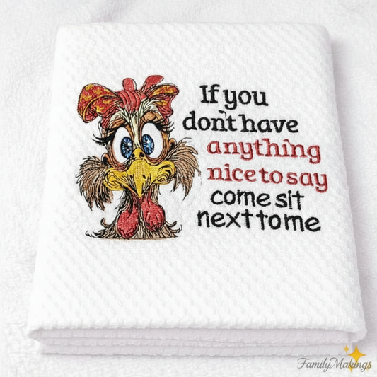 White towel with cartoon chicken and humorous text on a white background