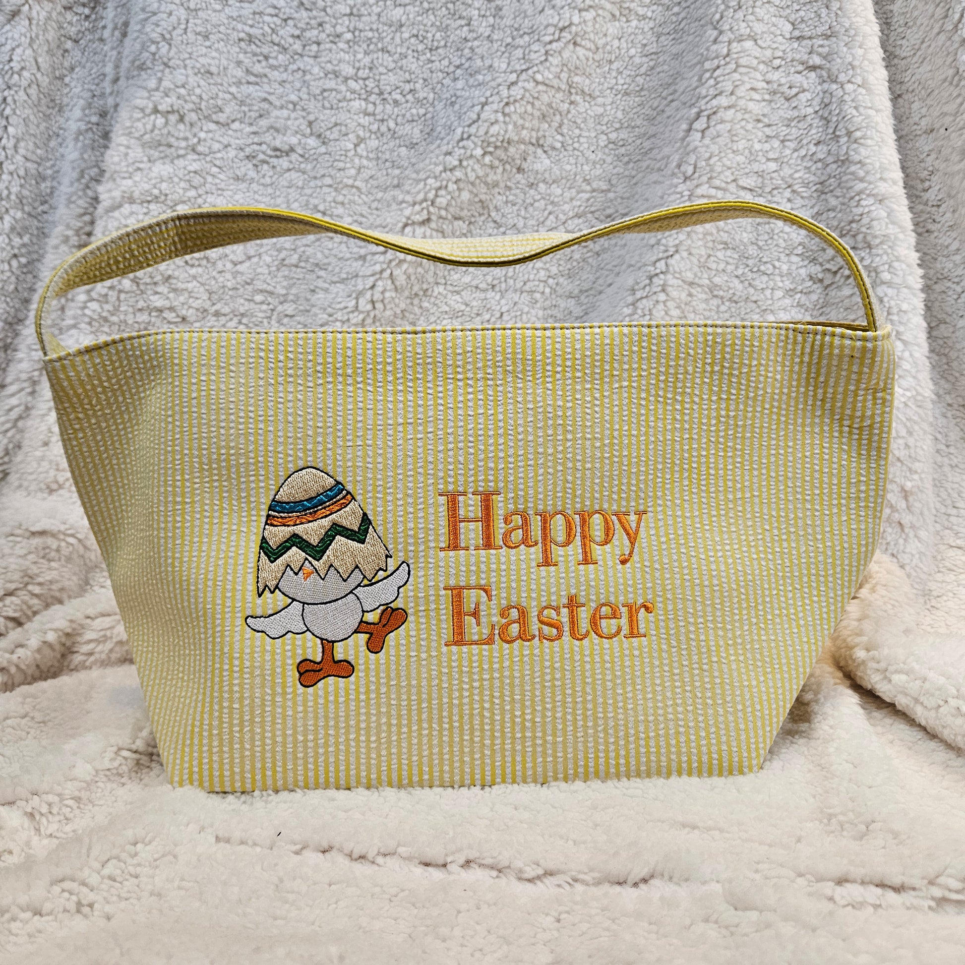 Yellow Easter bag with 'Happy Easter' text and bunny design embroidered on a textured surface