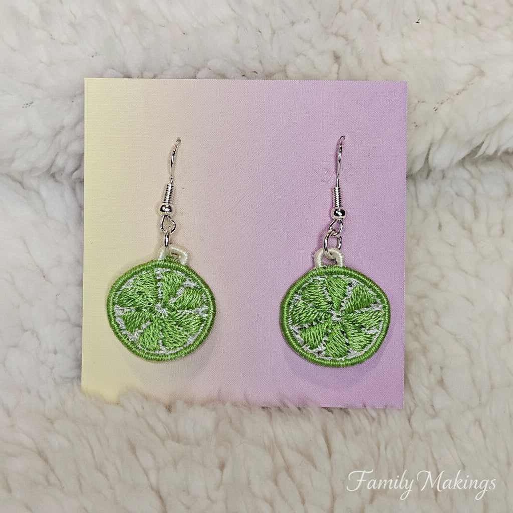 Embroidered Lime slice earrings with siver posts on a card