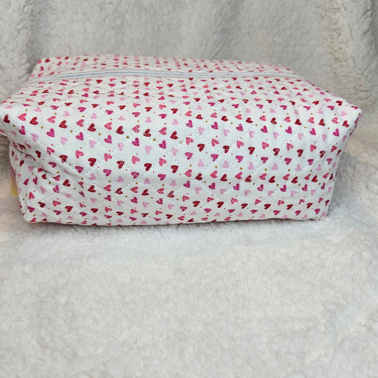 Rectangular bag with a pink heart pattern on a light gray background