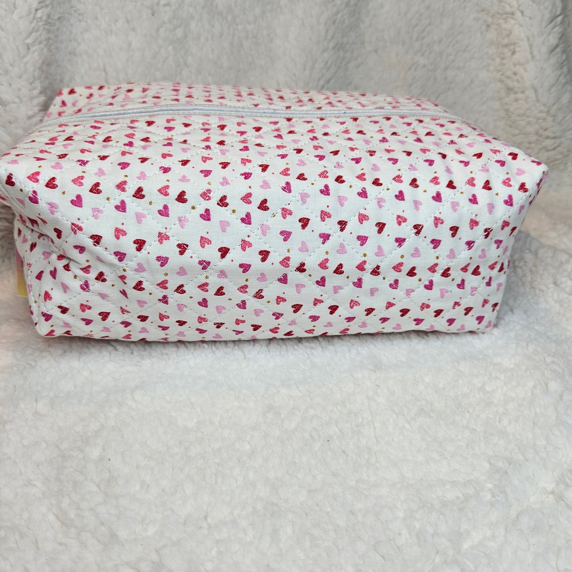 Rectangular bag with a pink heart pattern on a light gray background