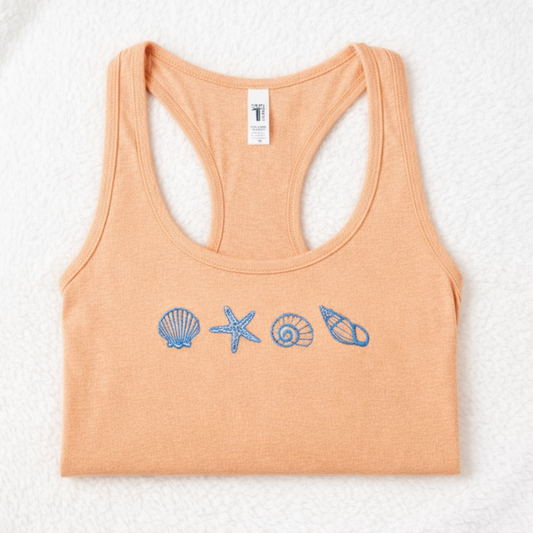 Light orange tank top with blue shell and starfish designs on a white background