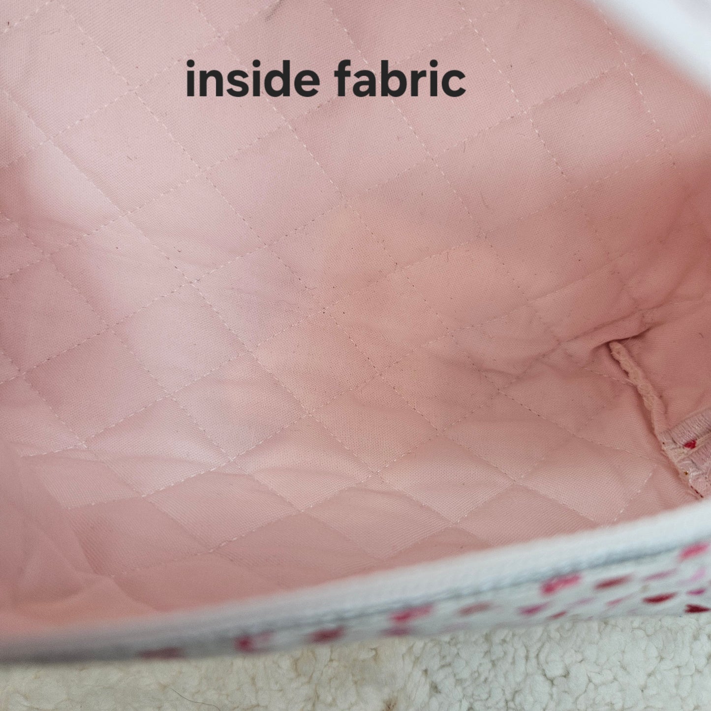 Close-up of pink quilted fabric with 'inside fabric' text.