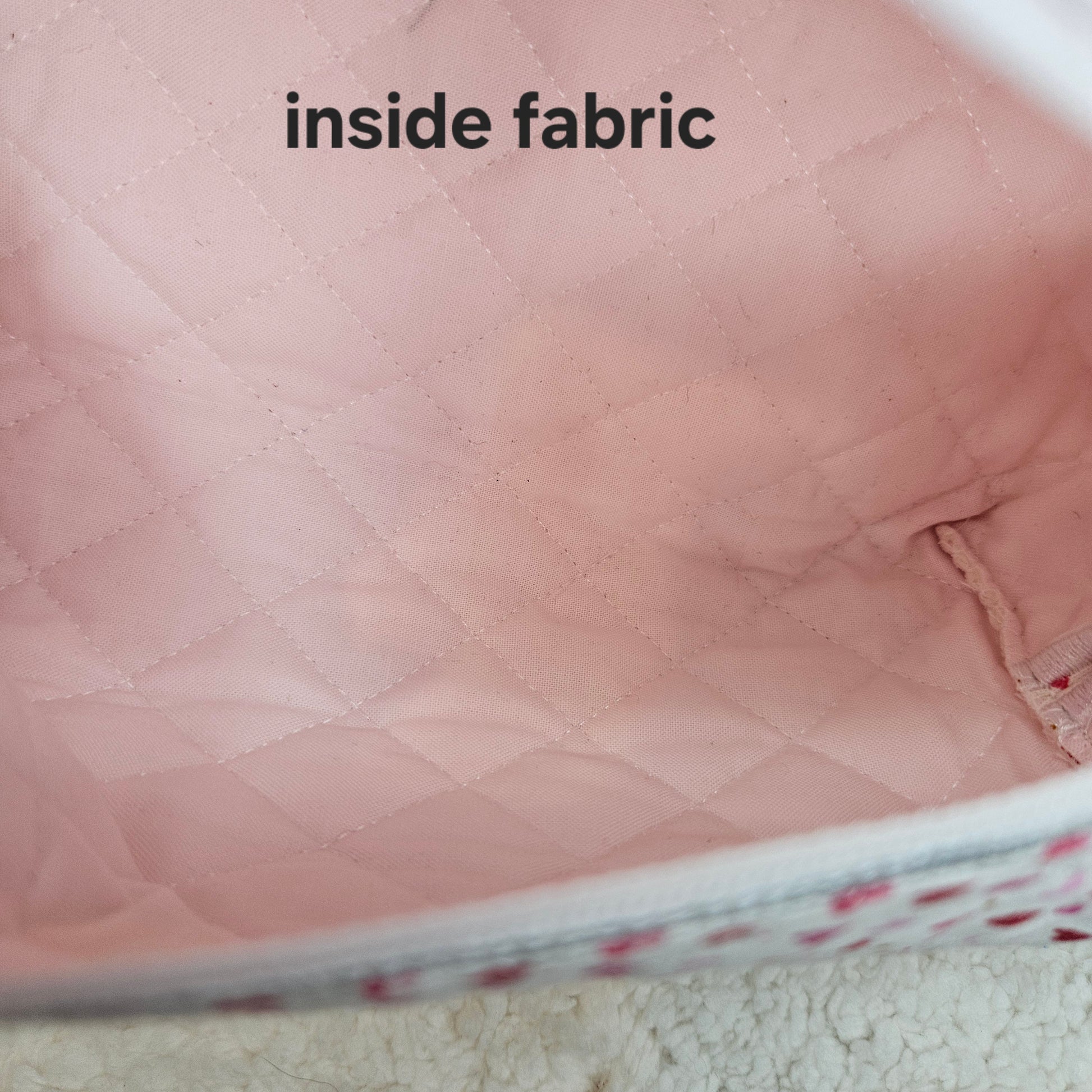 Close-up of pink quilted fabric with 'inside fabric' text.
