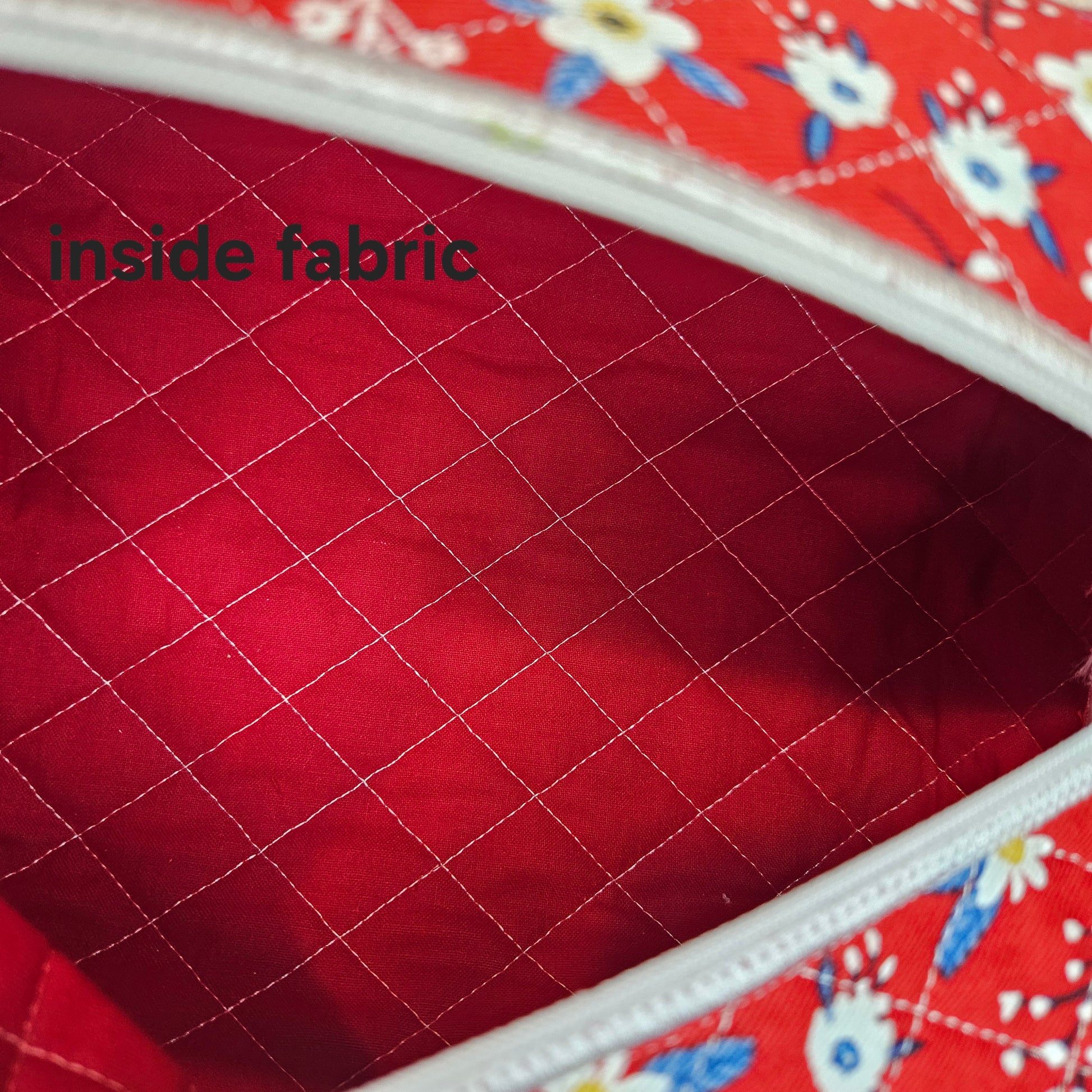 Red quilted fabric with floral pattern on border