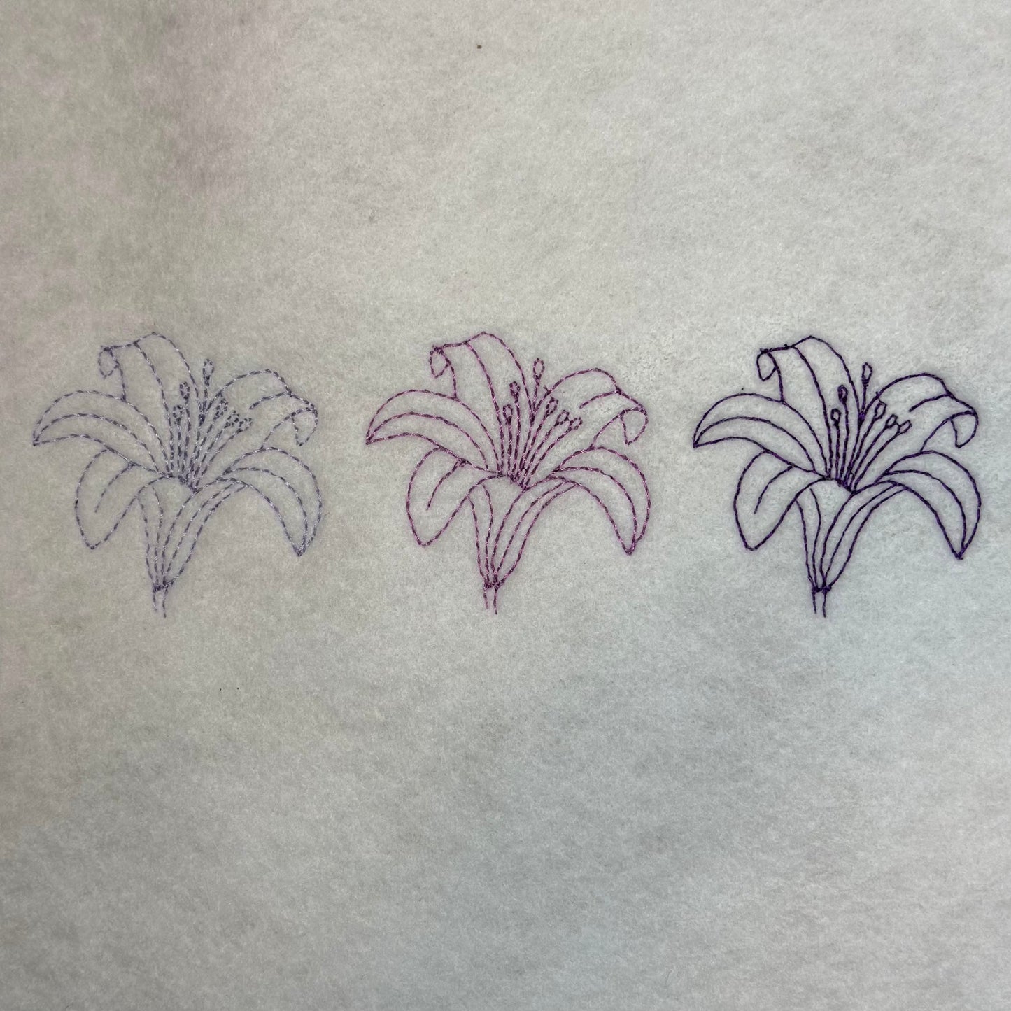 Three floral designs on a textured fabric background