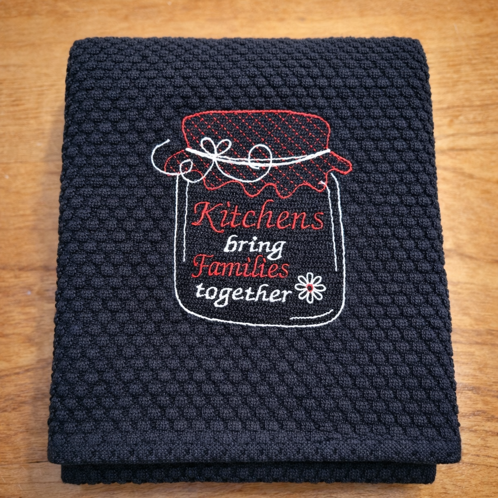 Black towel with red and white text and design on a wooden surface