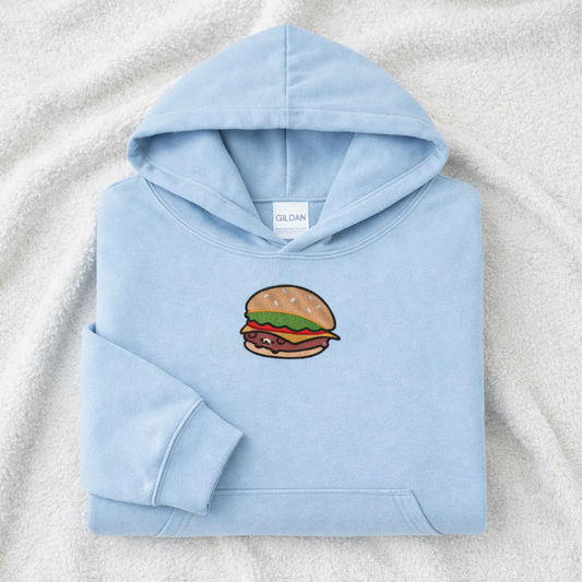 Light blue hoodie with a burger design on a textured surface
