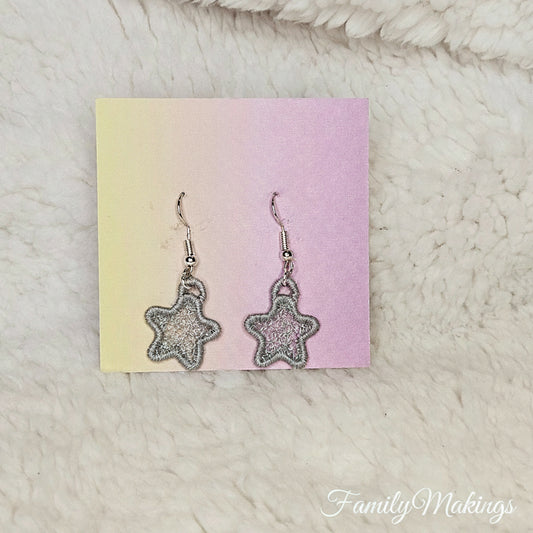 Gray embroidered star earrings on a card