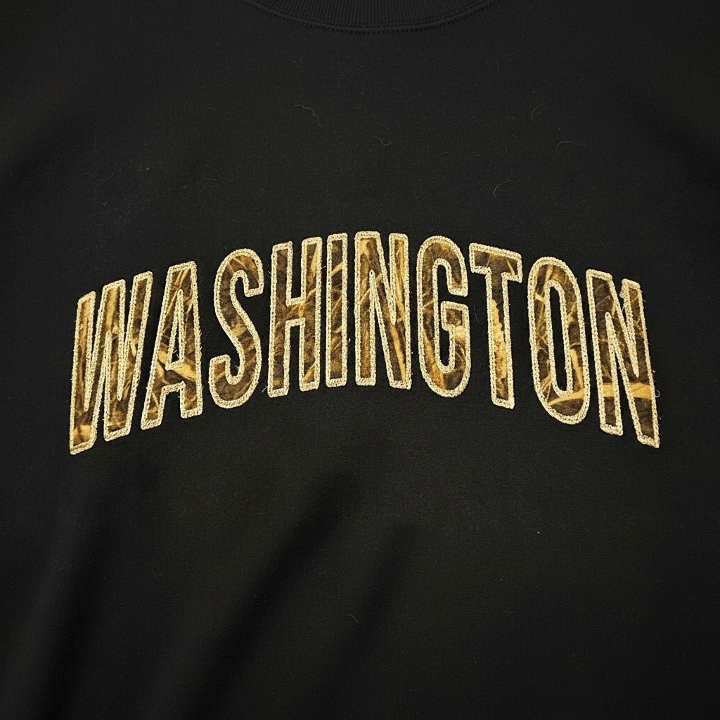 Black shirt with applique 'WASHINGTON' embroidered in beige
 on a dark background