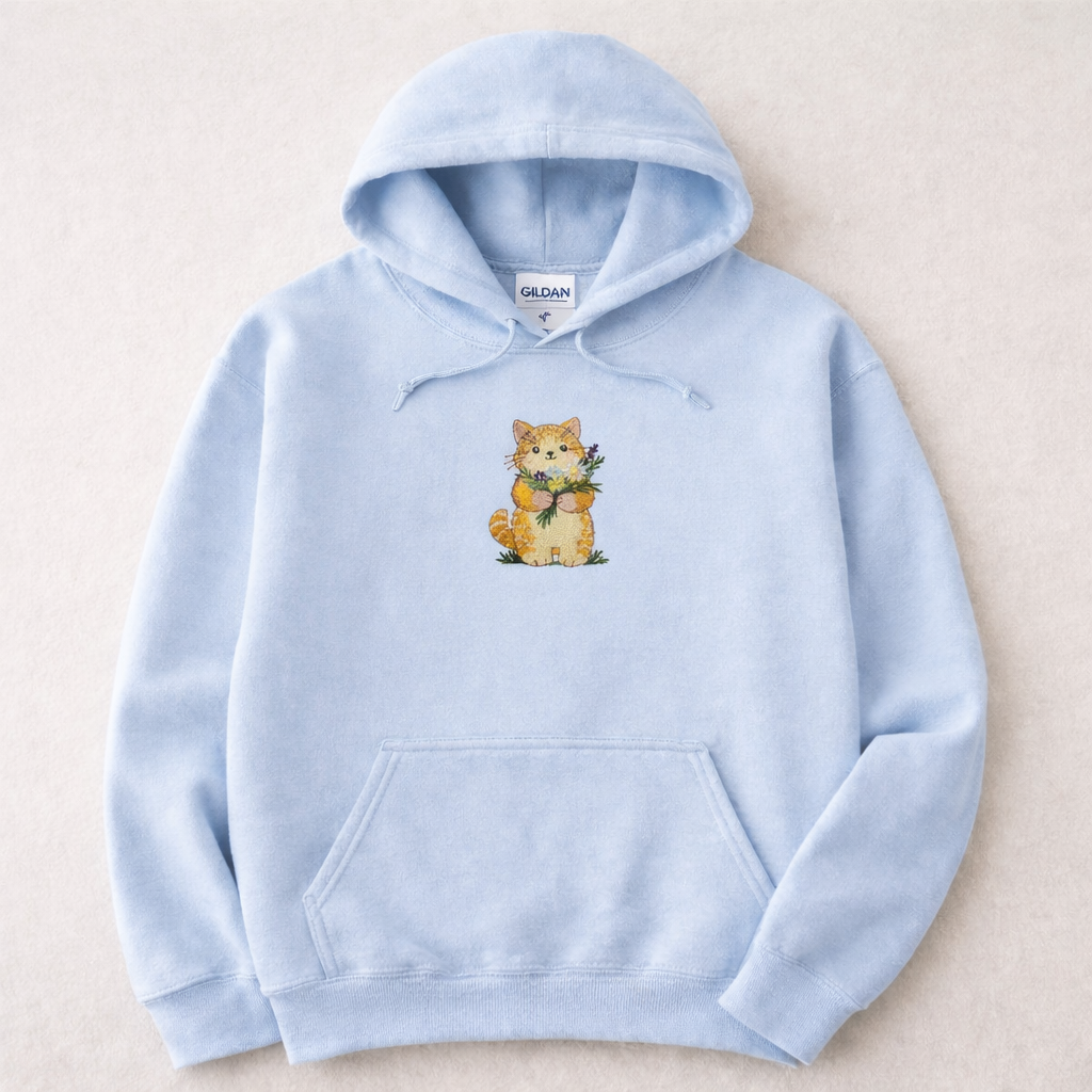 Light blue hoodie with a cat design on a beige background