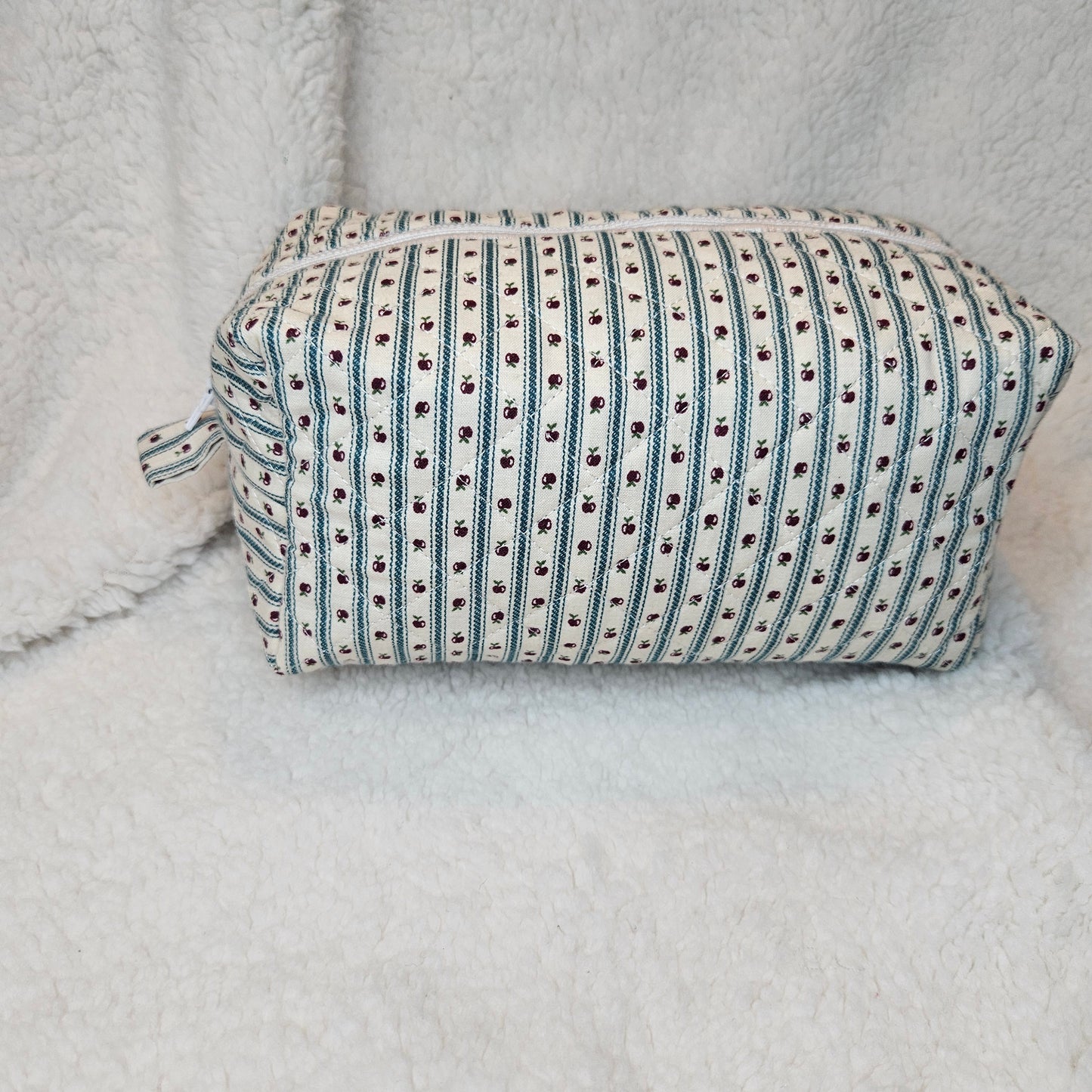 Striped bag with black pattern on a textured surface