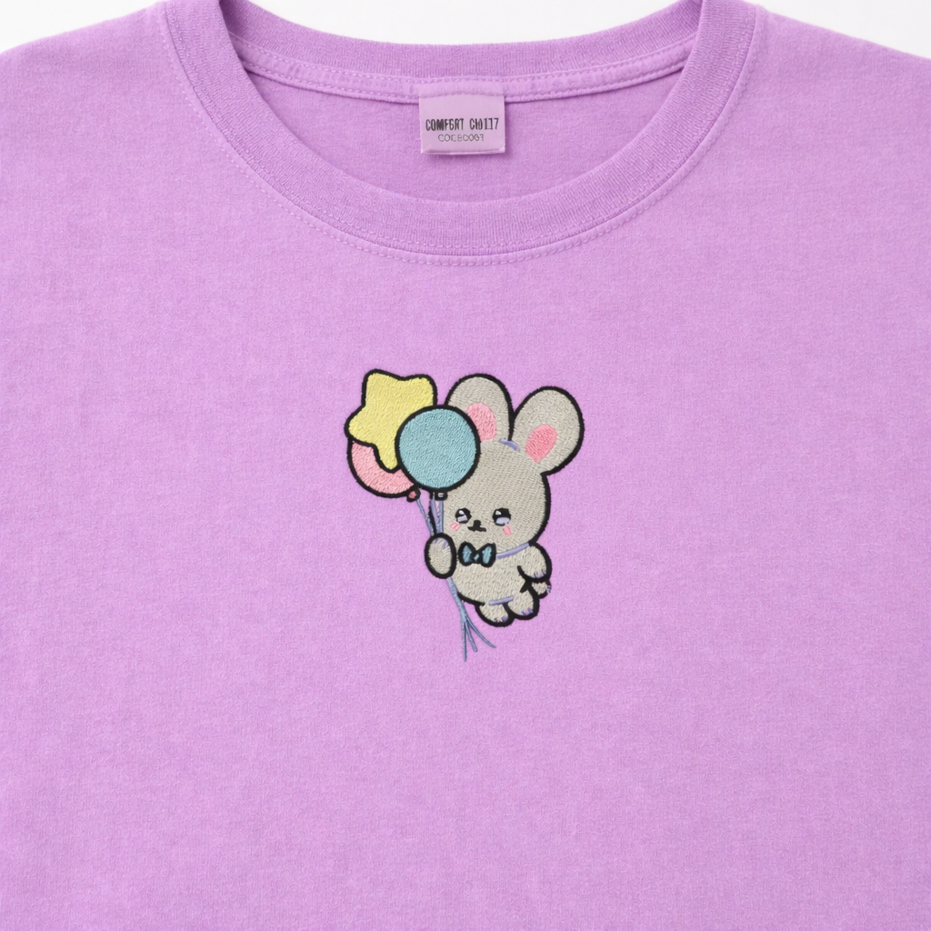 Orchid t-shirt with a cartoon bunny holding balloons design on a white background