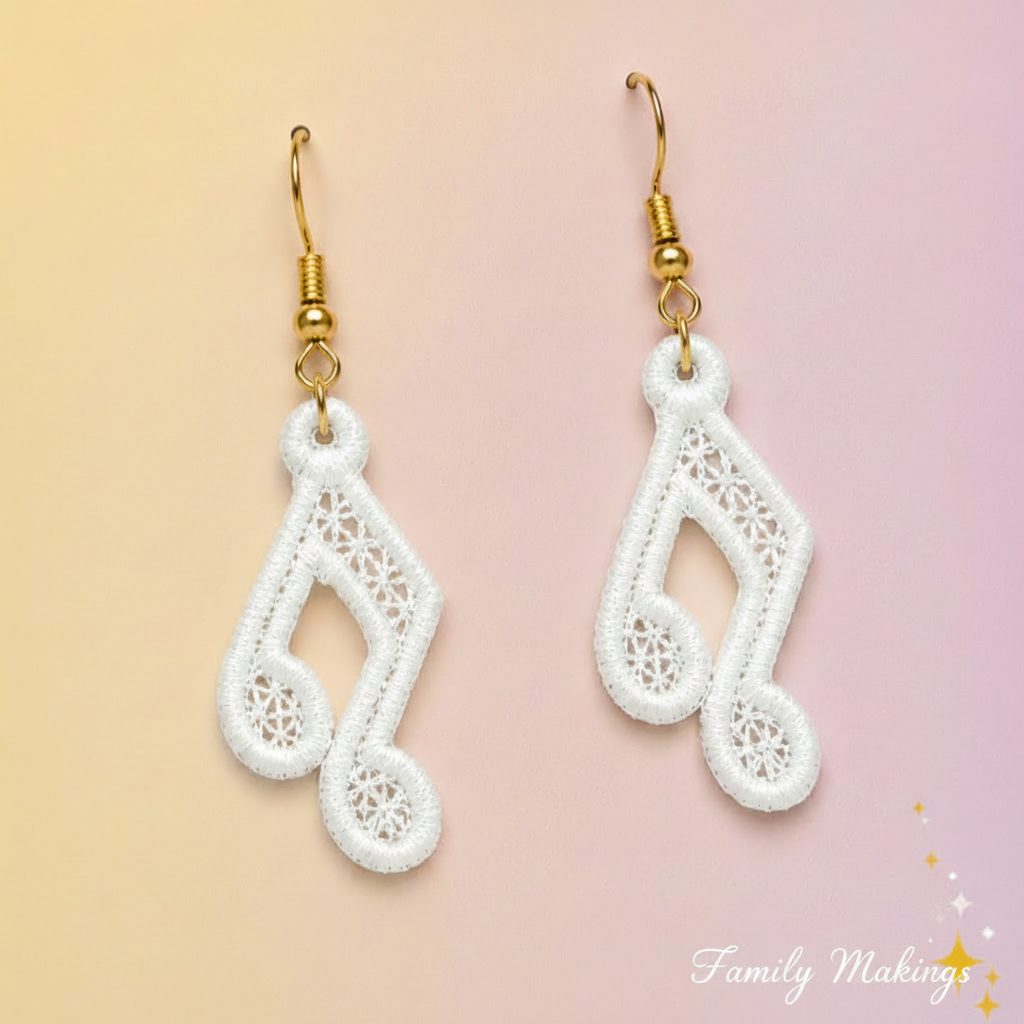 Beamed Eighth Noted embroidered earrings with white thread and gold posts on a card
