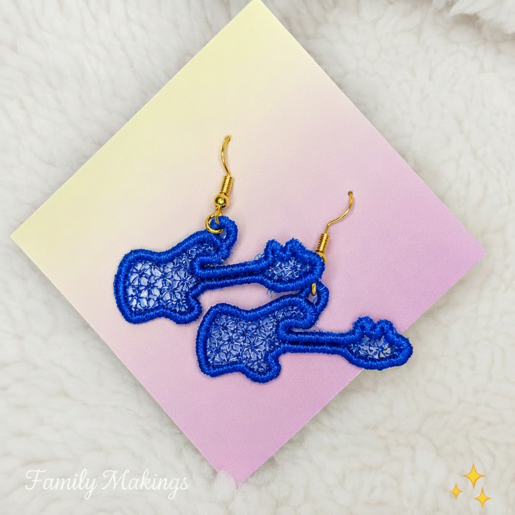 Royal blue embroidered guitar earrings on a card