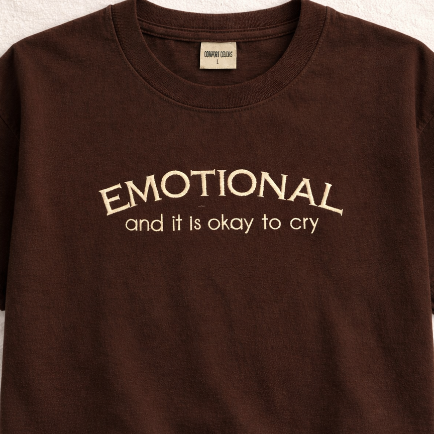 Espresso t-shirt with 'EMOTIONAL and it is okay to cry' embroidered text on a white background