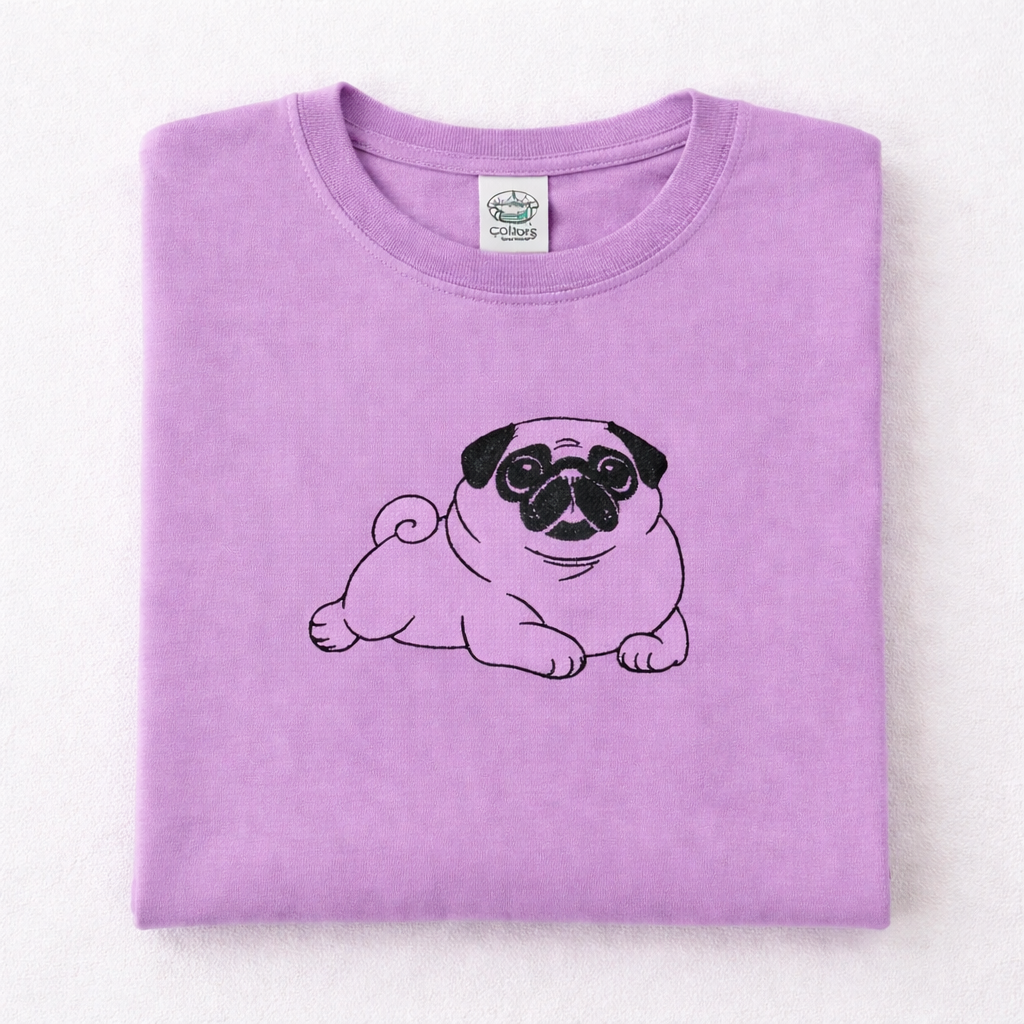 Folded orchid t-shirt with a pug design on a white background