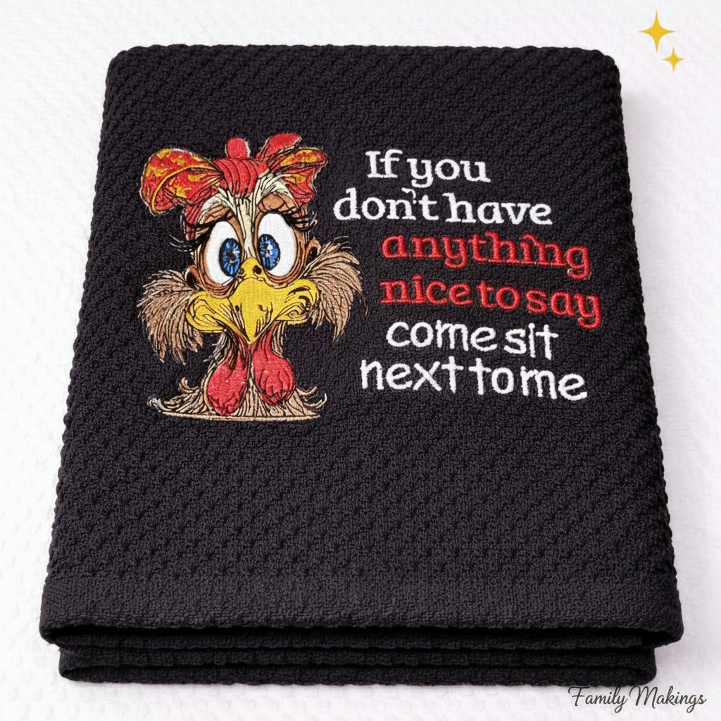 Black towel with cartoon chicken and humorous text on a white background
