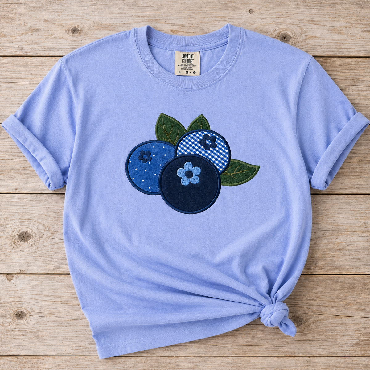 Hydrangea t-shirt with blueberry design on a wooden surface
