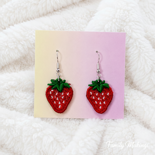 Embroidered strawberry earrings with silver posts on a card