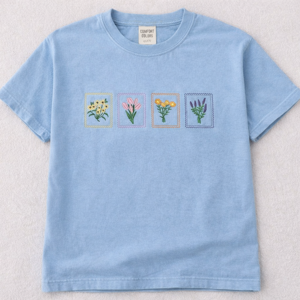 Hydrangea t-shirt with embroidered floral designs on a light gray background