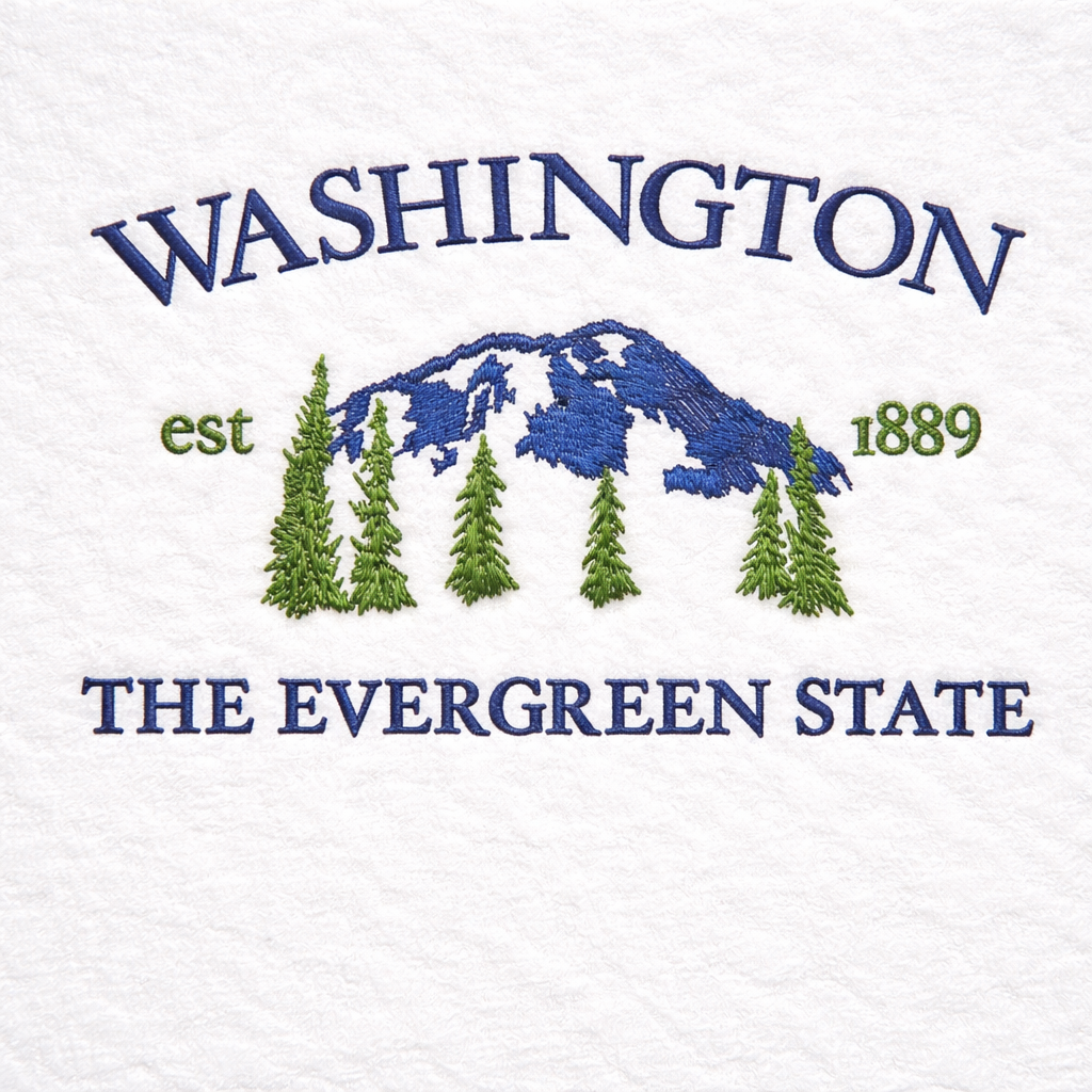 Embroidered design of a mountain and trees with 'Washington est 1889 The Evergreen State' text on a white background.