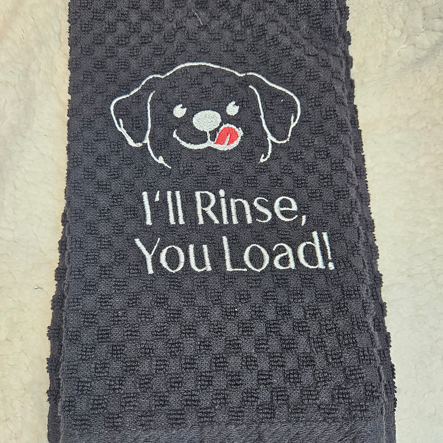 Black towel with a dog illustration and text on a beige background