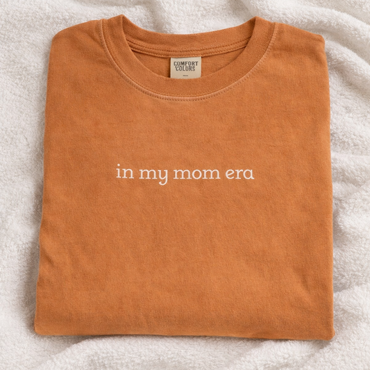 Folded yam t-shirt with embroidered design on a white blanket