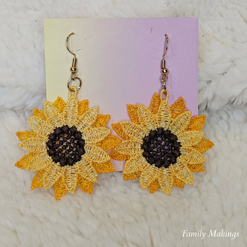 Sunflower embroidered earrings with gold posts on a card