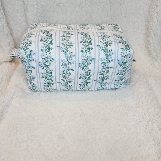 Floral-patterned boxy bag on a textured surface