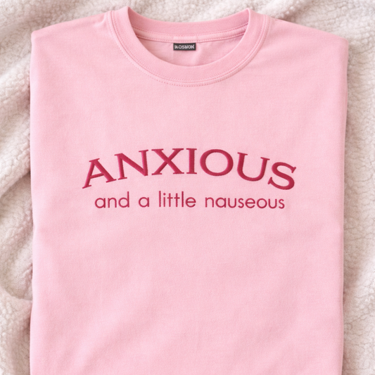 Blossom t-shirt with 'ANXIOUS and a little nauseous' embroidered text on a textured surface