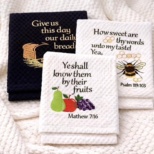 Set of three embroidered towels with religious text and illustrations on a textured surface.