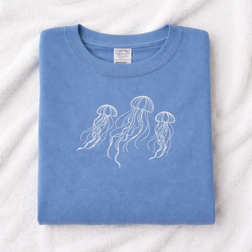 Folded hydrangea t-shirt with white jellyfish design on a white background