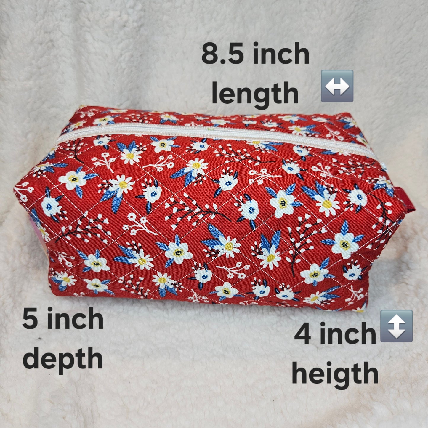 Red floral-patterned fabric roll with measurements on a gray background