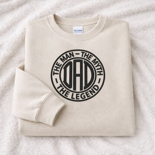 Folded sand sweatshirt with 'The Man - The Myth - The Legend' text on a white background